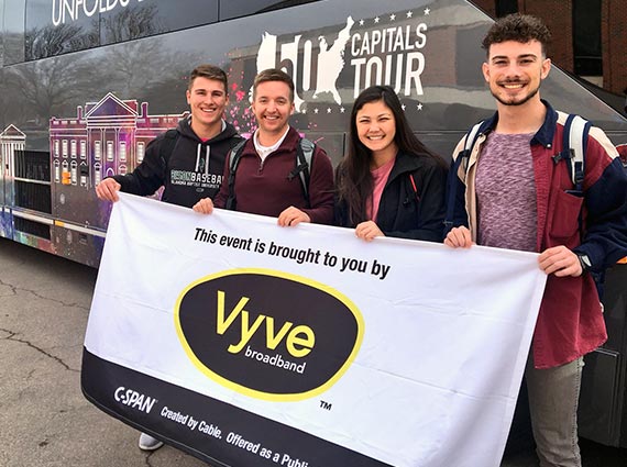 Shawnee students pose with a Vyve banner outside the CSPAN 50 Capitals Tour bus