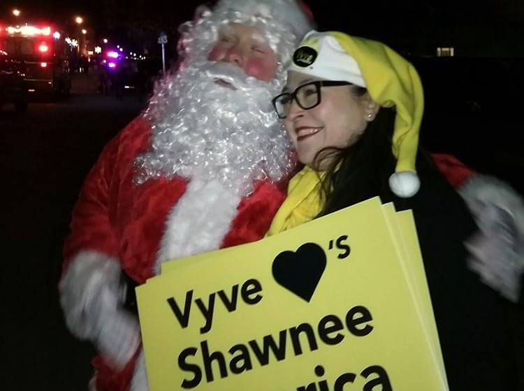 Vyve employee poses with Santa during the Shawnee Christmas Parade