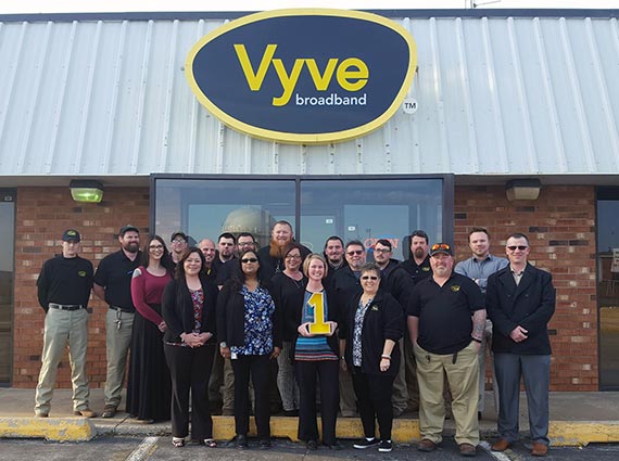 Vyve employees pose for a picture outside the Shawnee Vyve Headquarters